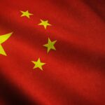 A realistic shot of the waving flag of China with interesting textures